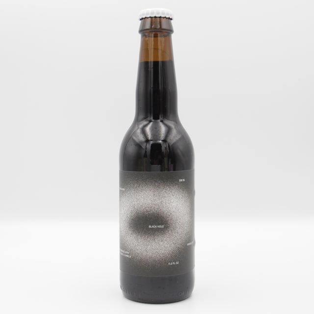 This is a bottle of Mikkeller - Black Hole - 13.1% (330ml). It is a Imperial Stout / Porter craft beer available to buy from Ghost Whale, voted London's best craft beer shop.