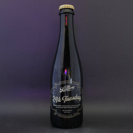 This is a bottle of The Bruery - 24K Tuesday - 17.5% (375ml). It is a Imperial Stout / Porter craft beer available to buy from Ghost Whale, voted London's best craft beer shop.