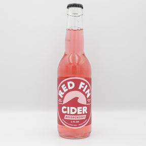 This is a bottle of Red Fin Cider - Meloncherry Cider - 3.4%. It is a  craft cider available to buy from Ghost Whale, voted London's best craft beer shop.
