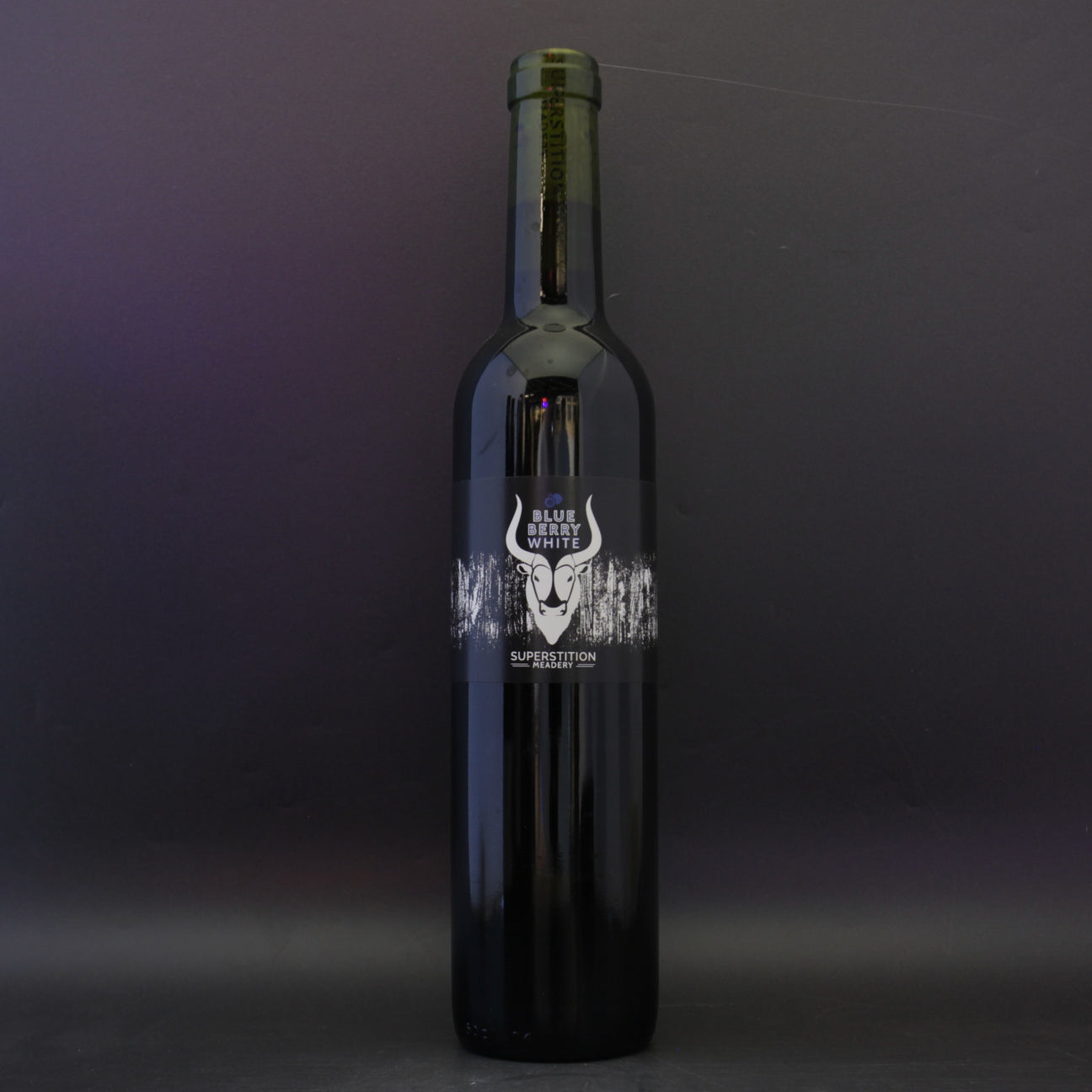 This is a bottle of Superstition Meadery - BlueBerry White - 13.5% (500ml). It is a  craft mead available to buy from Ghost Whale, voted London's best craft beer shop.