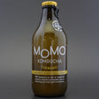 This is a bottle of Momo - Turmeric Kombucha - 0% (330ml). It is a  craft soft drink available to buy from Ghost Whale, voted London's best craft beer shop.